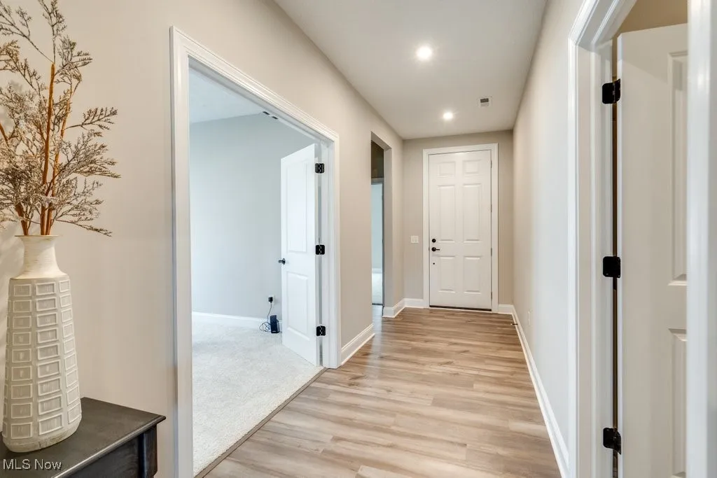 Hall with recessed lighting and light wood-style flooring