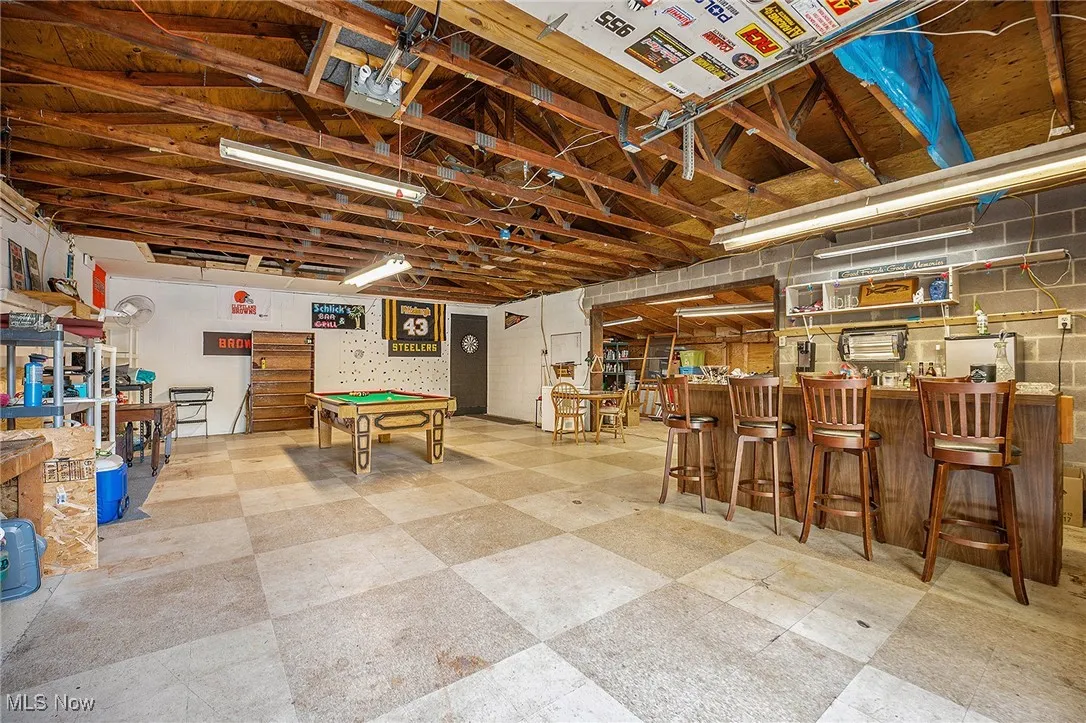 Rec room featuring light floors, pool table, and a garage