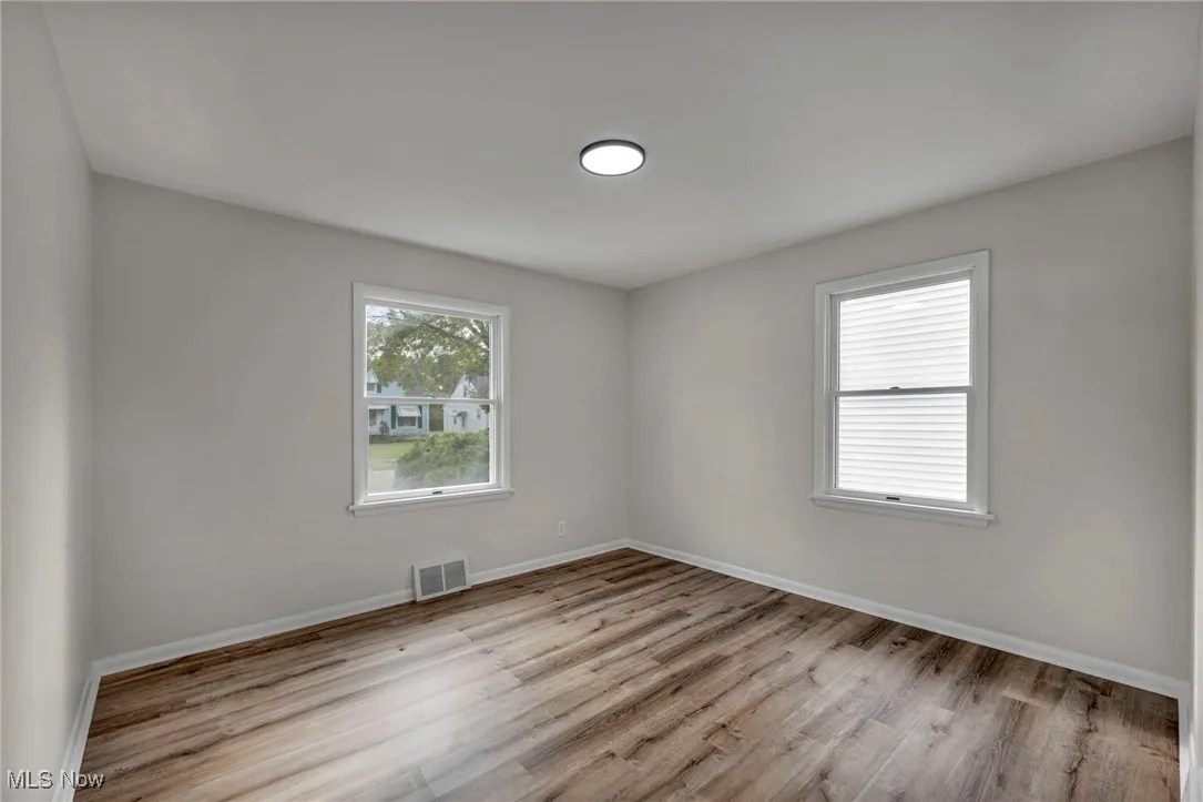 Empty room featuring plenty of natural light and light wood-style floors