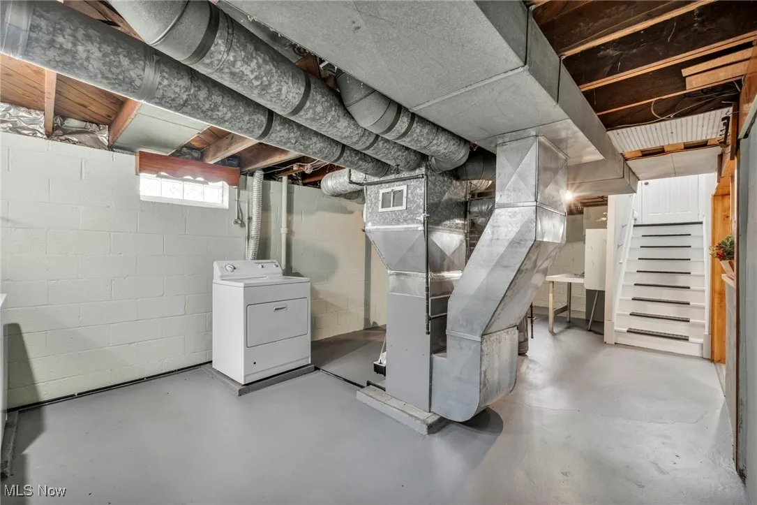 Below grade area featuring washer / dryer and stairs