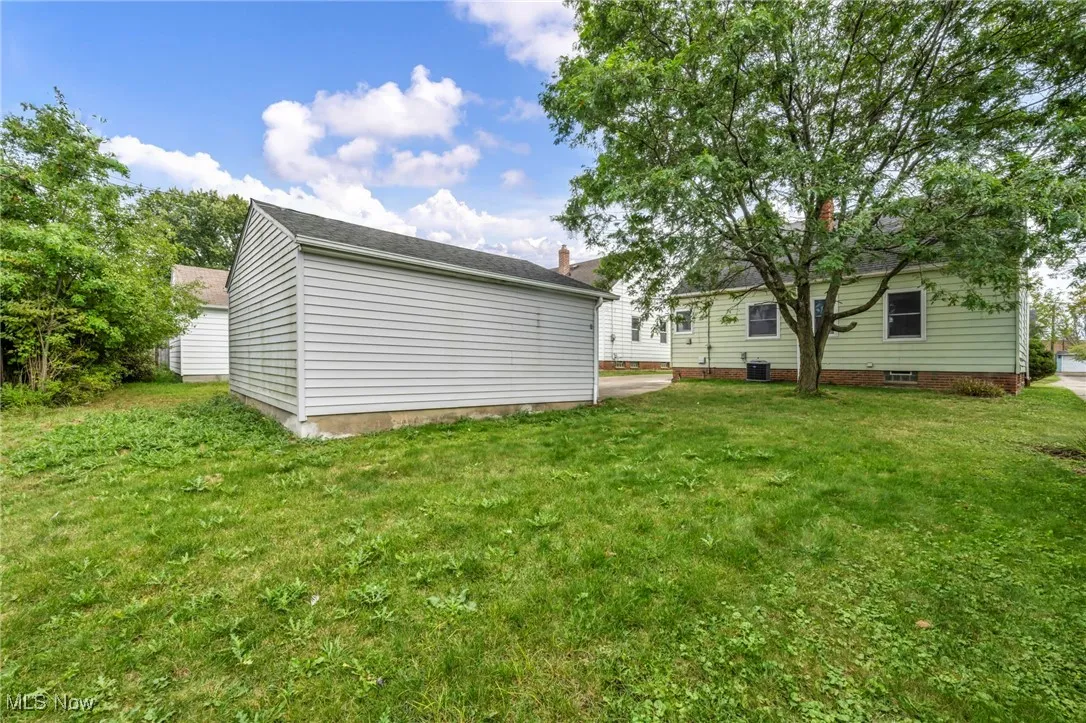 Rear view of house featuring a yard
