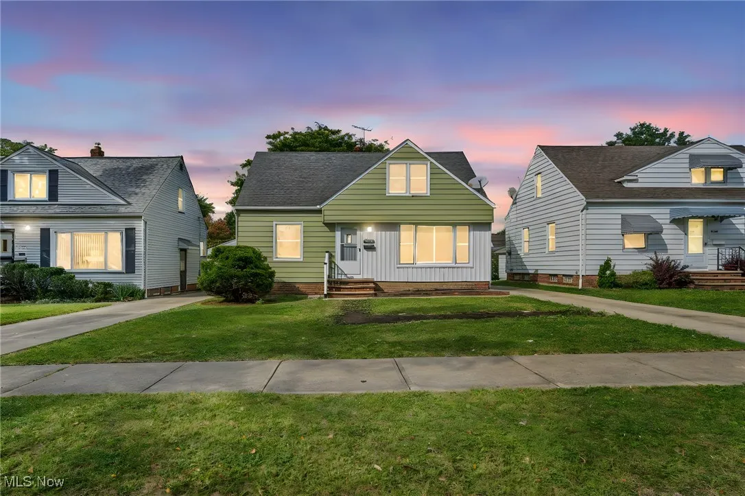 Bungalow-style home with a front yard and entry steps