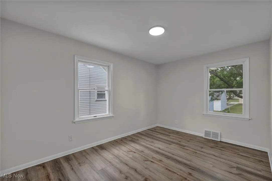 Spare room with wood finished floors and plenty of natural light