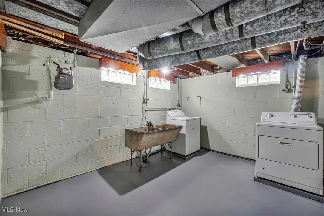 Basement featuring separate washer and dryer and a sink