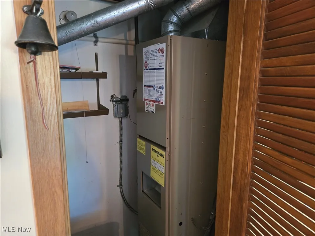 Utility room featuring heating unit