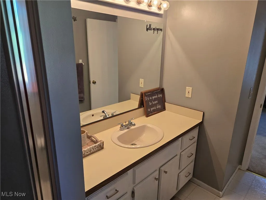Bathroom with vanity and light tile patterned flooring