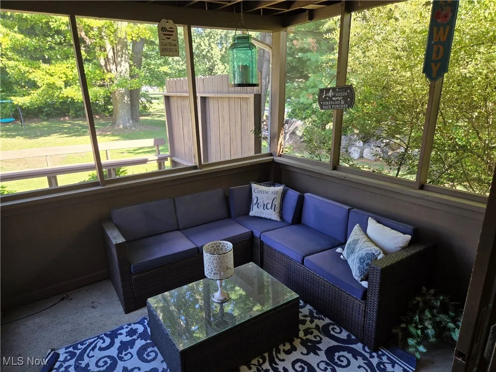 Sunroom / solarium featuring healthy amount of natural light and outdoor lounge area