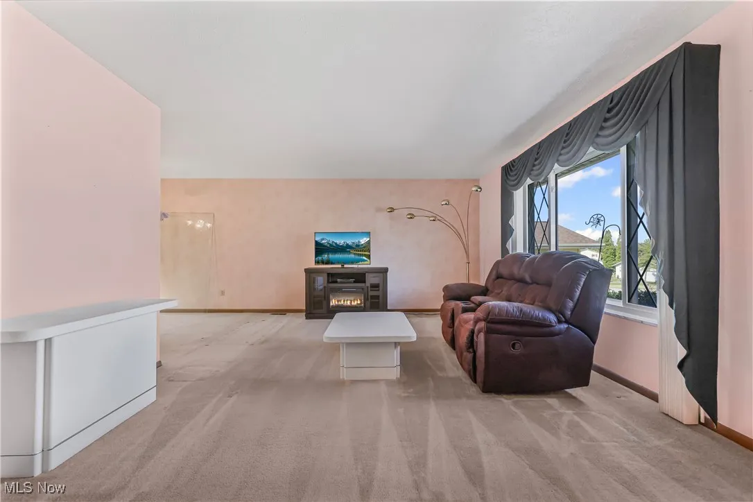 Living room with light carpet and picture window