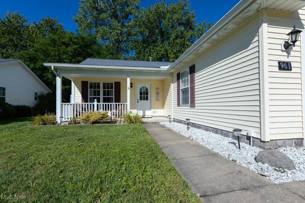 View of front of house featuring a porch and a front lawn