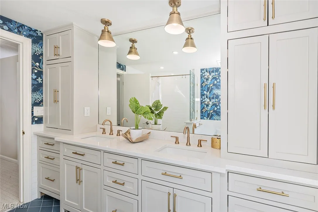 Second floor hallway Bathroom with double vanity, wallpapered walls, a shower with curtain, and dark tile patterned floors