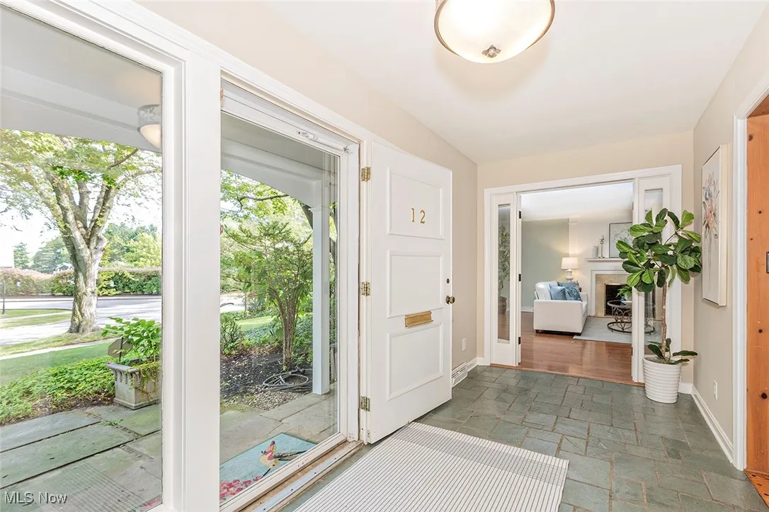Foyer featuring stone tile flooring and a fireplace