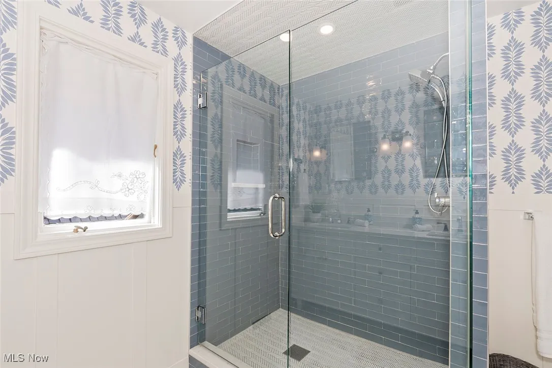 Full bath with wallpapered walls, a stall shower, and recessed lighting