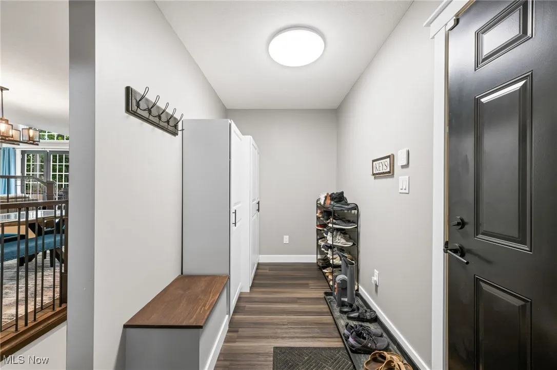 Mudroom with access to garage and hallway to half bathroom and dining room.