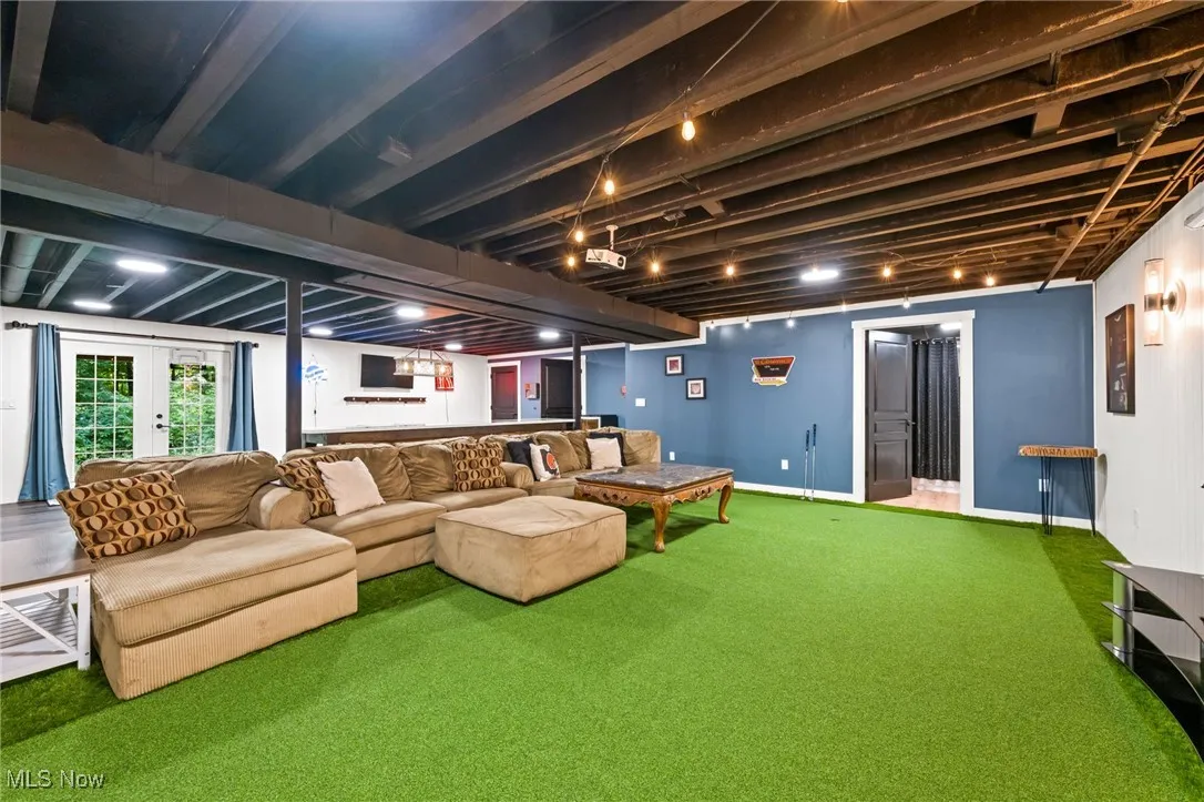Finished basement recreation room with french door egress to sideyard.