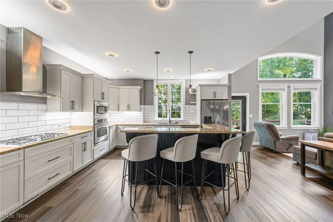 Just WOW! Stunning kitchen with oversized subway tile backsplash, soft close cabinetry and stainless steel appliances.