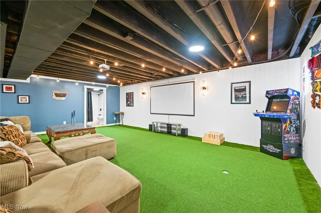 Custom turf putting green with two holes, projector screen and access to full bathroom.