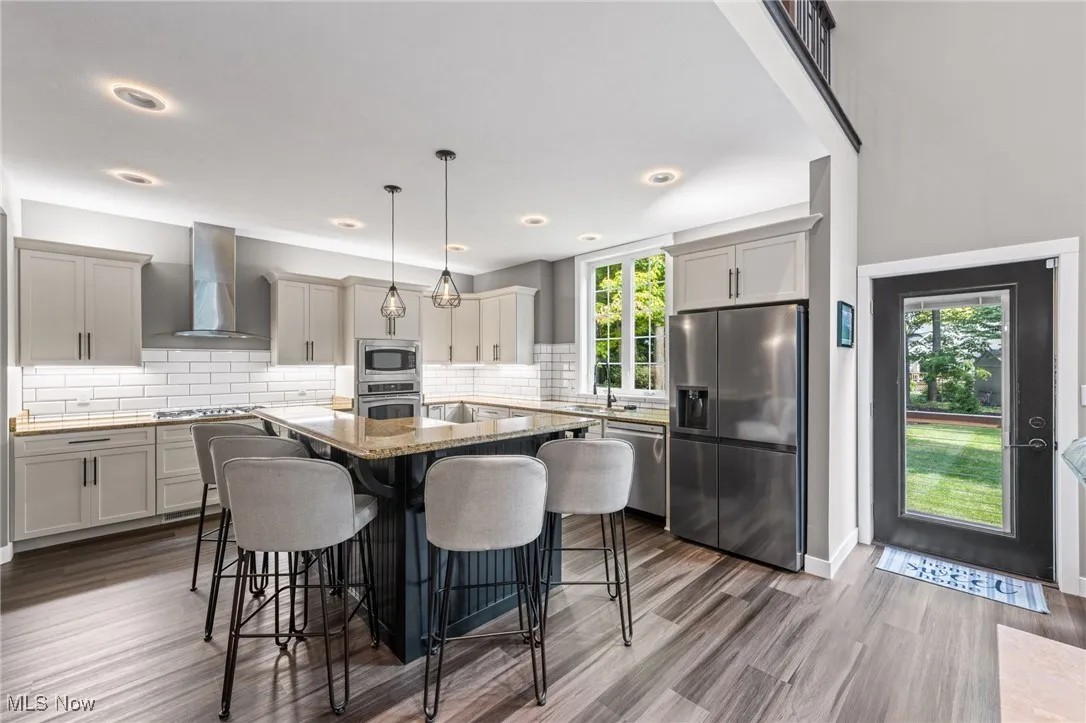 Kitchen featuring lighting above and below cabinetry with door to deck.