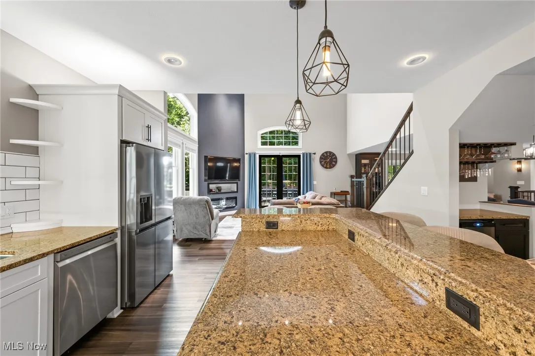 Large center granite island with additional storage and breakfast bar.
