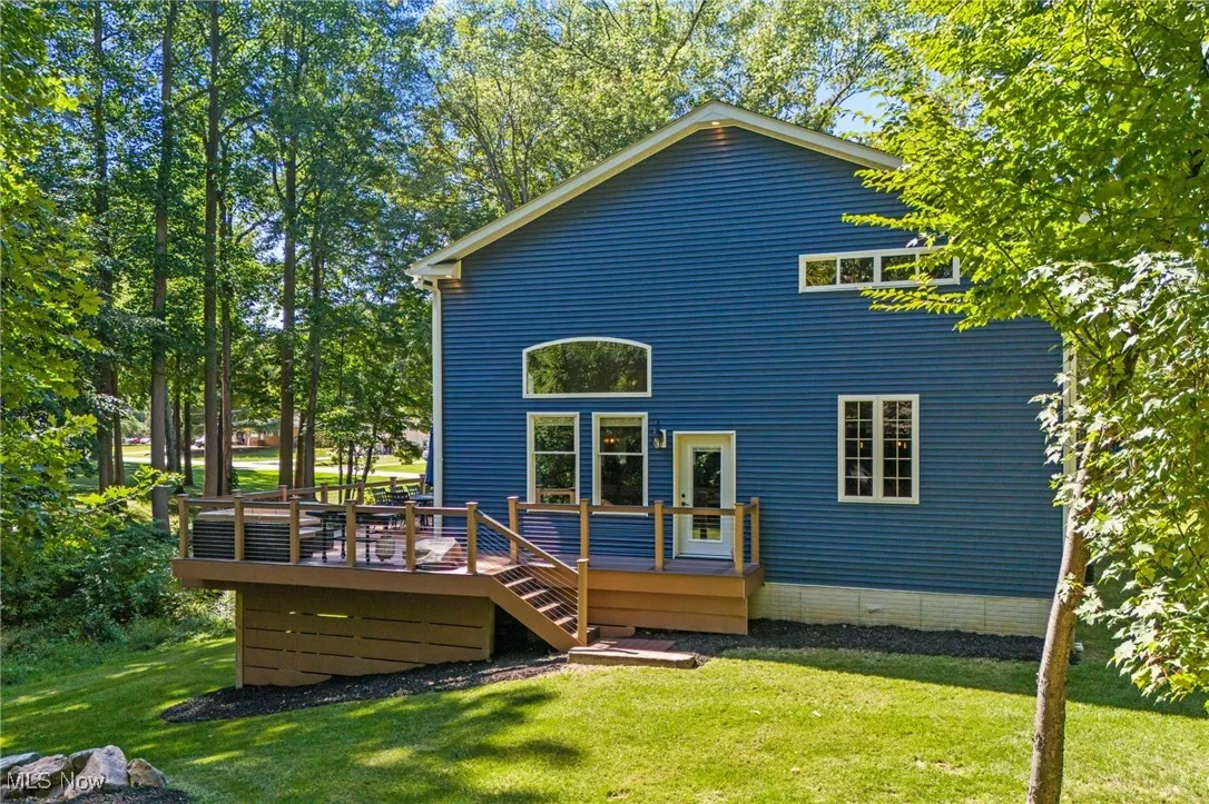 Back of home featuring LED smart lighting and wrap around Trex deck.