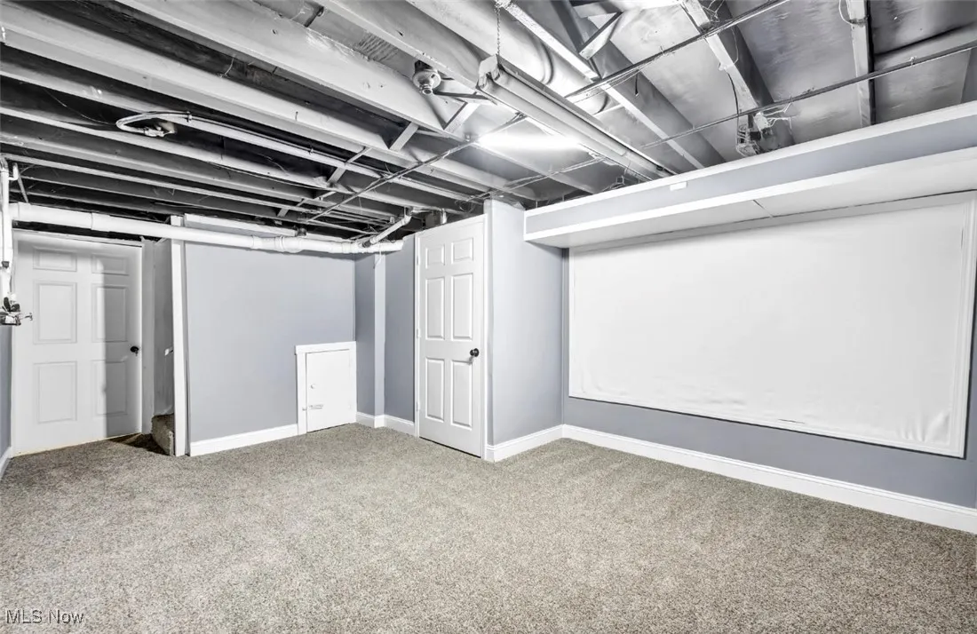 Finished below grade area with baseboards and carpet flooring