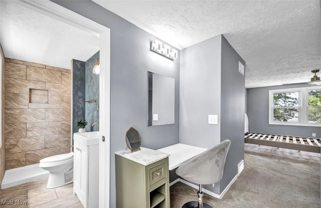 Home office featuring a textured ceiling and baseboards