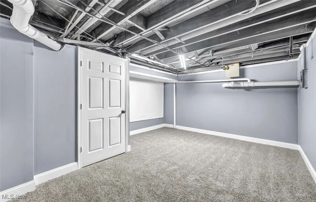 Finished below grade area featuring carpet and baseboards