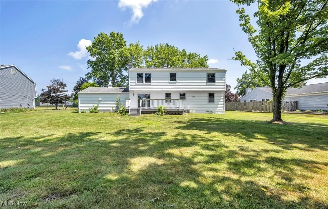 Rear view of house featuring a deck and a chimney
