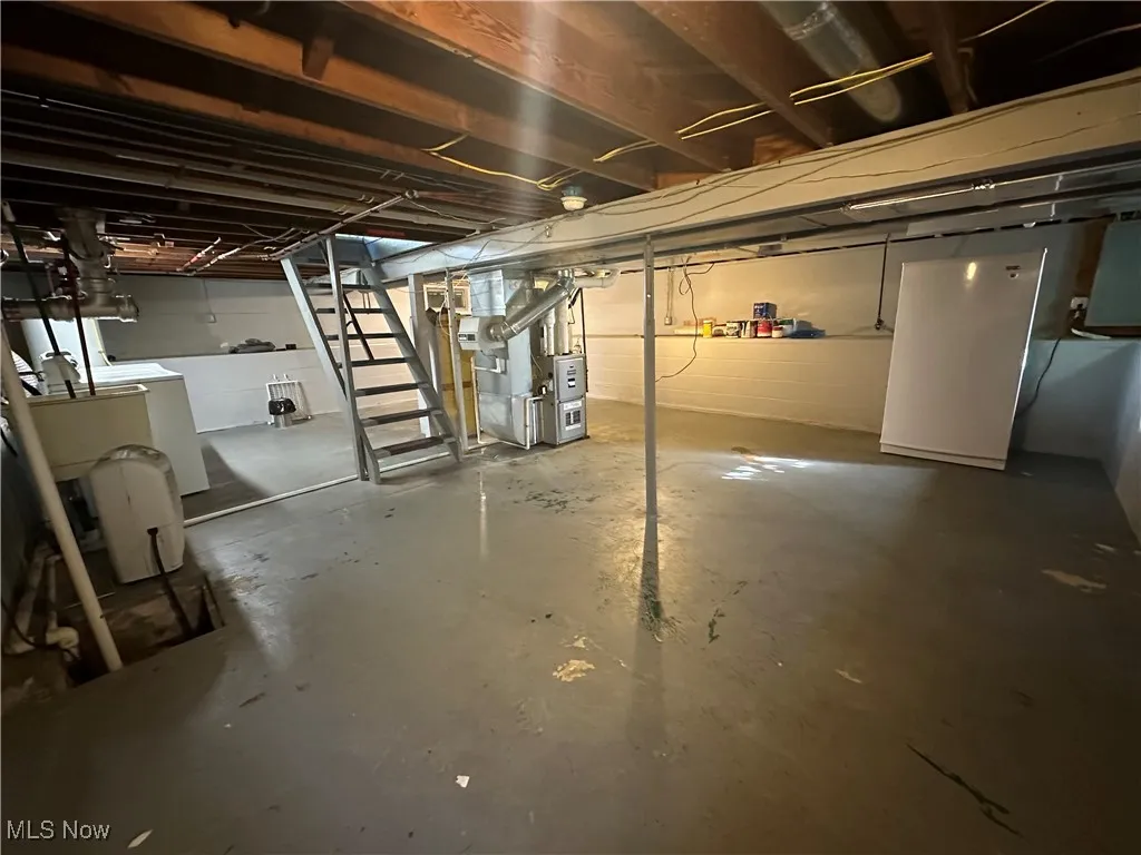 Basement houses the laundry, utilities, & sump pump. The ledge all the way around makes for great storage.