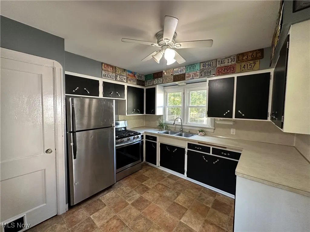 Kitchen comes with stainless steel refrigerator and stove, plus double stainless steel sink.