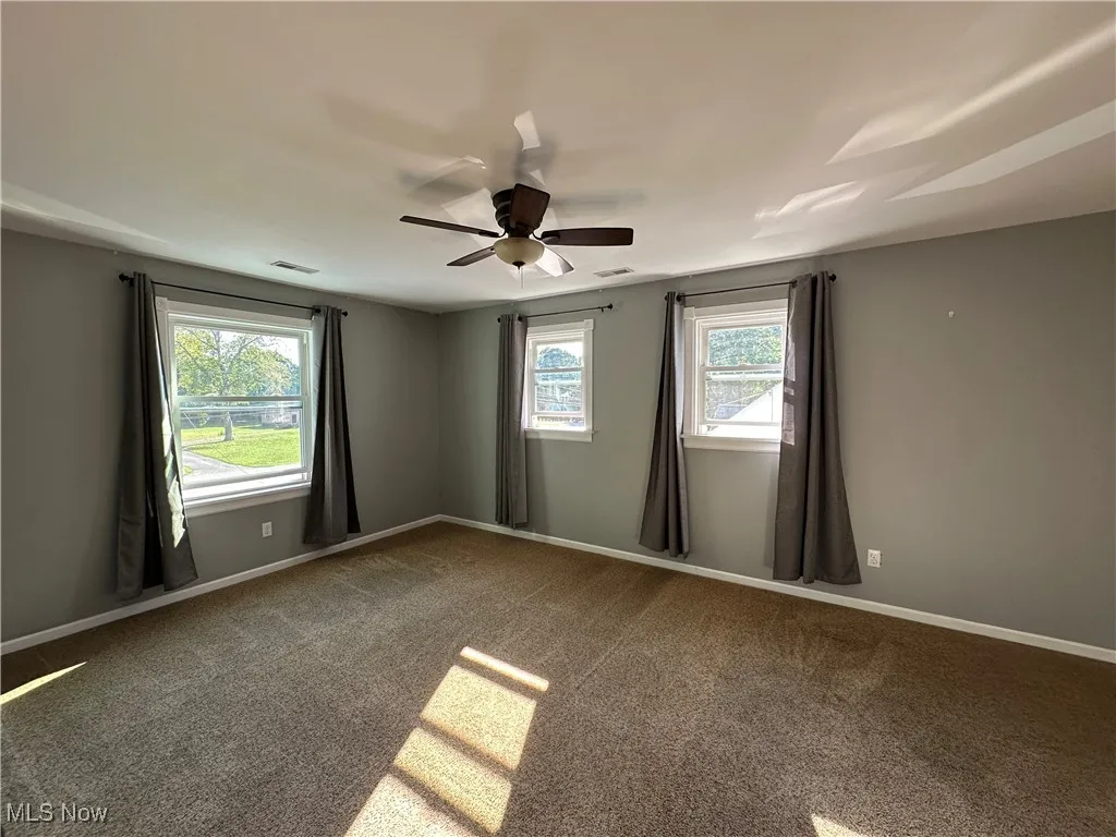 Primary bedroom is very large with so much natural light seeping in.
