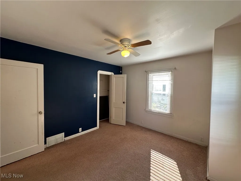 1st floor bedroom w/ view of closet.