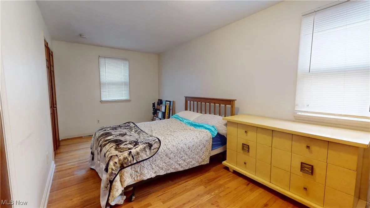 Bedroom with light wood-style flooring and baseboards