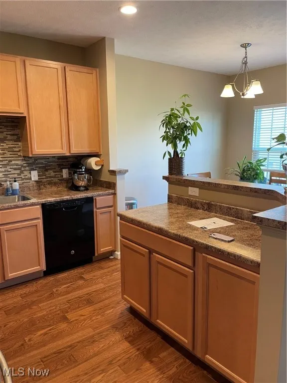 Kitchen with tasteful backsplash, dishwashing machine, dark wood-style floors, light brown cabinetry, and recessed lighting