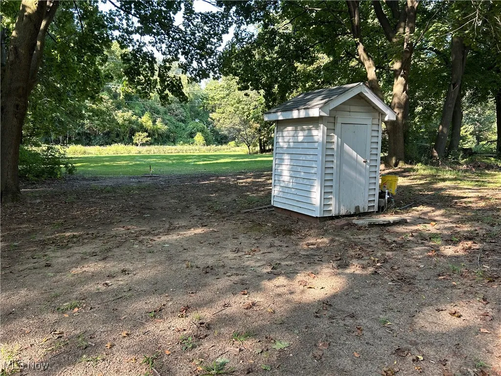 View of shed with view of wooded area