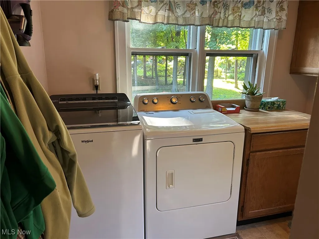 Laundry area featuring cabinet space and washer and dryer