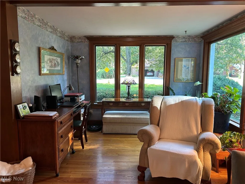 Sitting room with wood-type flooring, an office area, and plenty of natural light