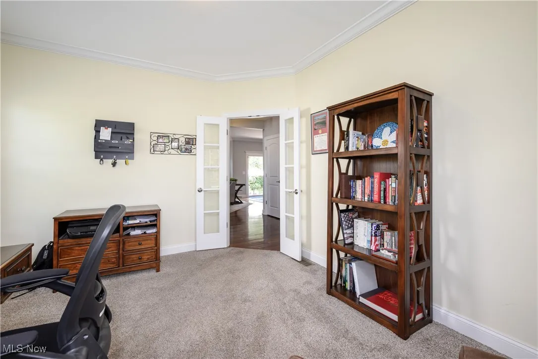 Carpeted Office featuring french doors, crown molding