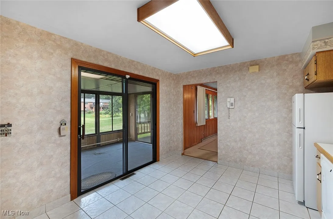 Kitchen eating area with access to enclosed porch