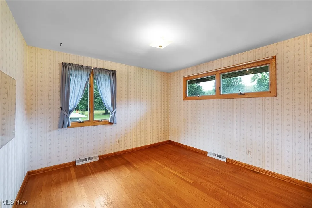 Bedroom 2 with hardwood flooring