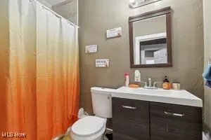 Bathroom featuring vanity and a shower with shower curtain