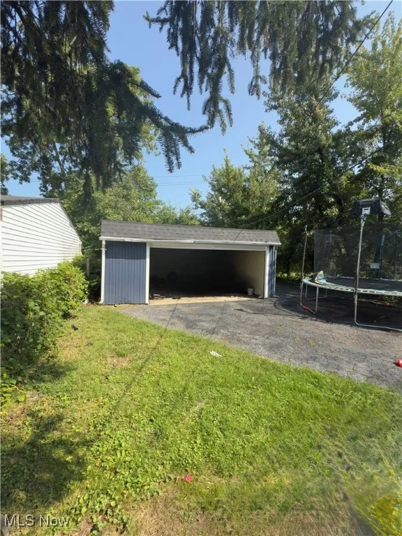 View of outbuilding with a trampoline