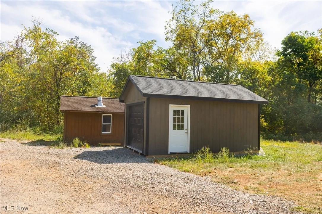 View of outbuilding with driveway