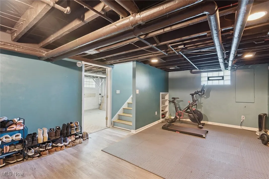 Workout area with baseboards and wood finished floors