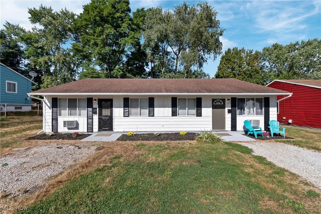 Ranch-style home featuring a front yard, board and batten siding, a porch, and a shingled roof