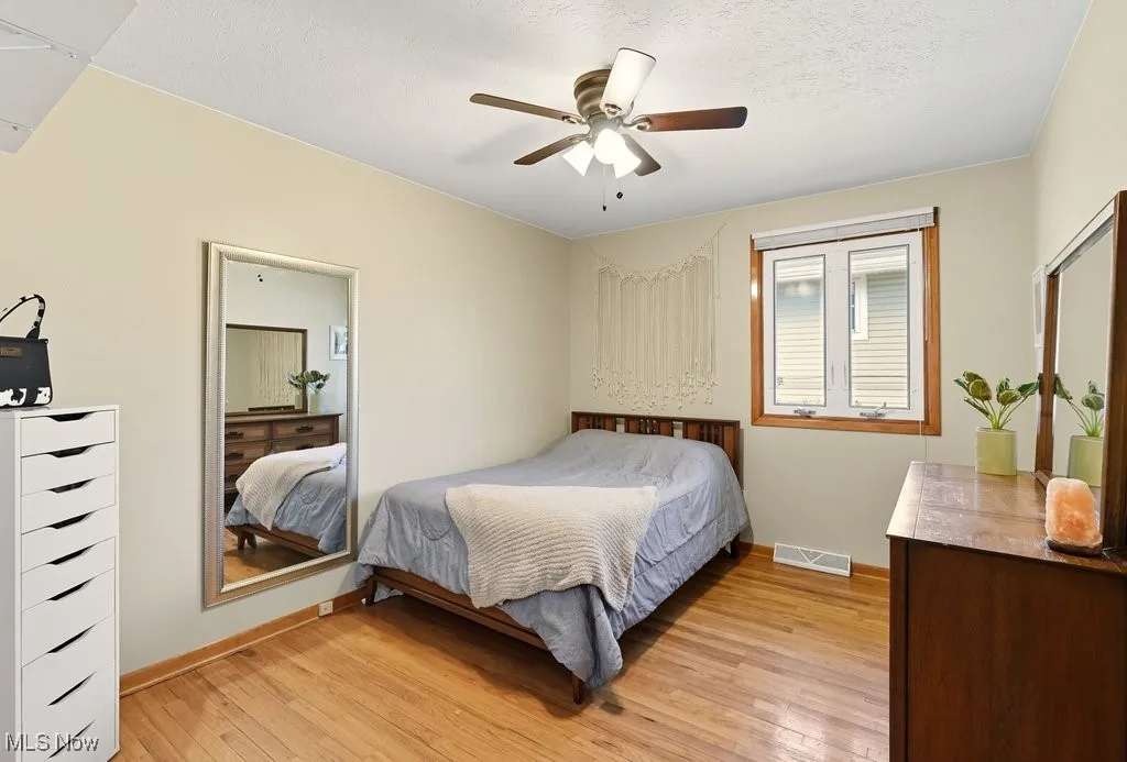 Bedroom with hardwood floors and ceiling fan
