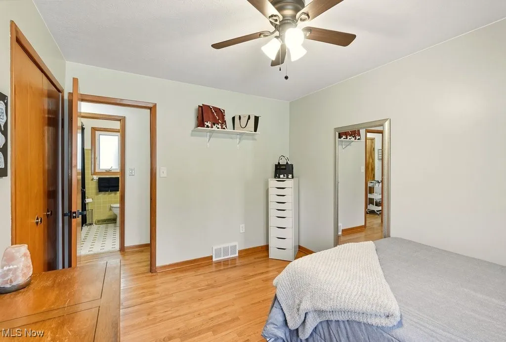Bedroom with hardwood floors & a ceiling fan