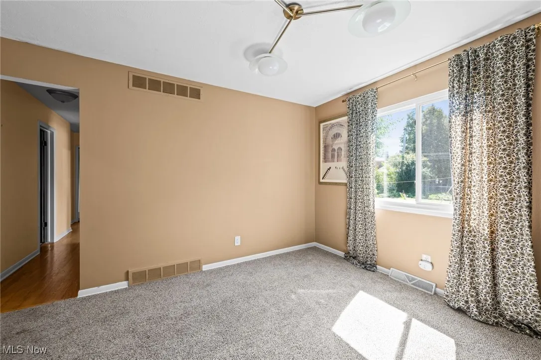 Unfurnished Dining room featuring carpet and baseboards