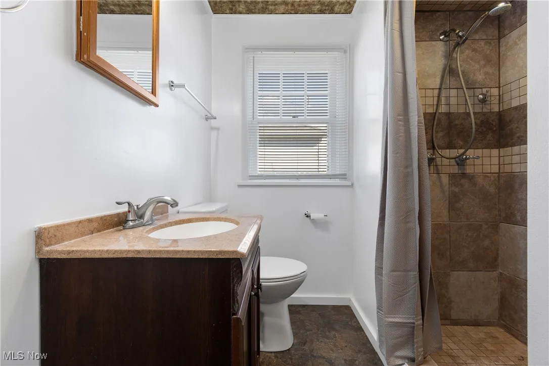 Full bath featuring vanity and a stall shower