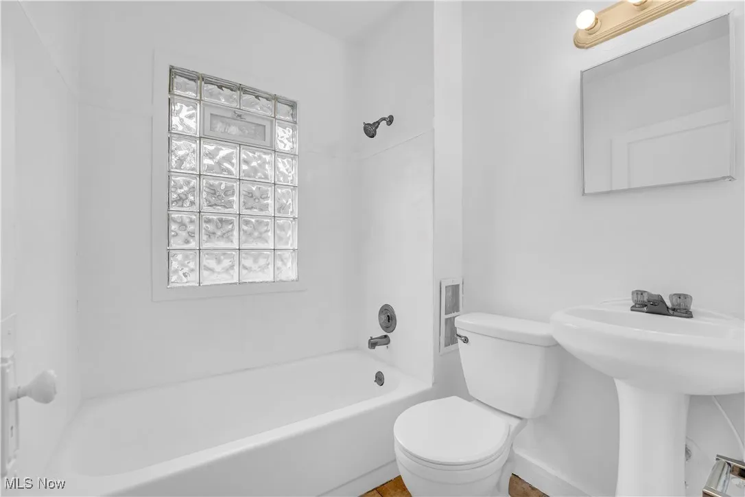 Full bath featuring bathing tub / shower combination and toilet