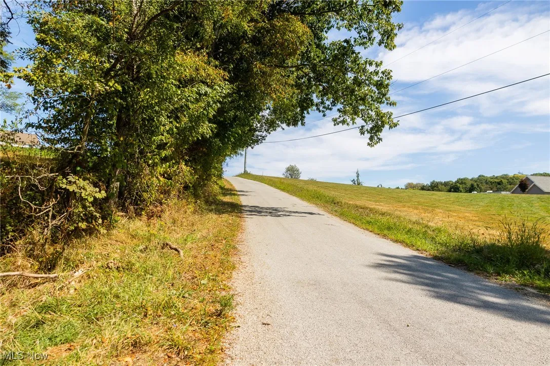 View of asphalt street featuring a rural view
